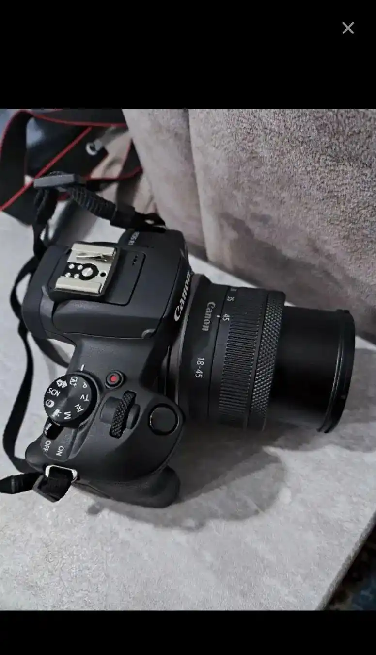 دوربین بدون آینه کانن مدل Canon EOS R100 18-45mm دست دو